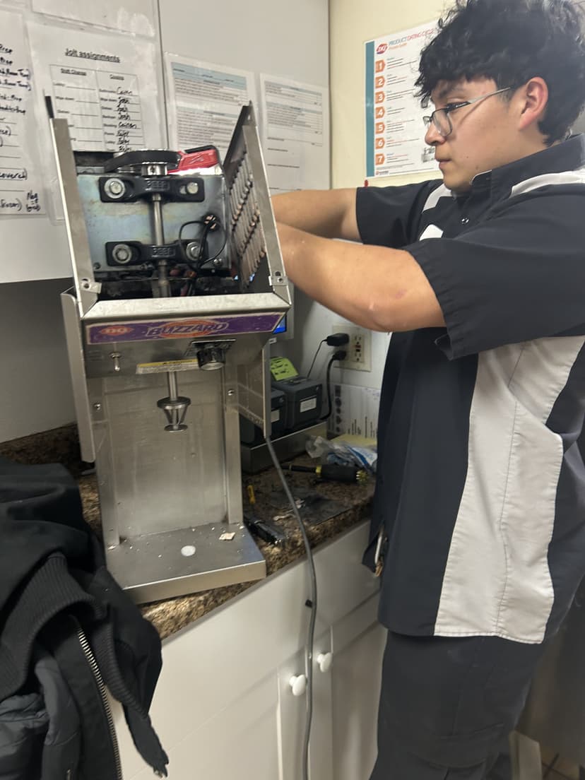 Technician servicing commercial ice cream machine