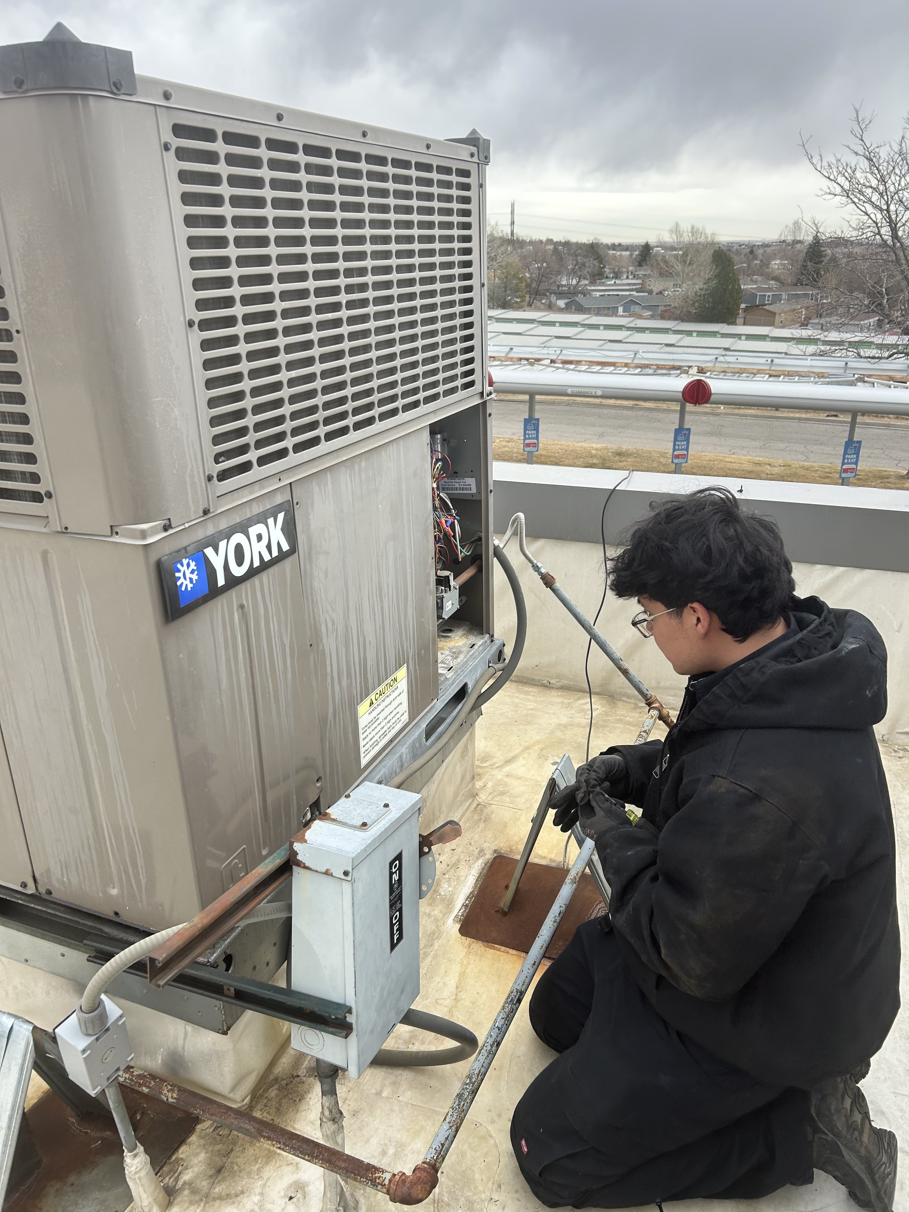Eagle Repair technician servicing rooftop HVAC unit